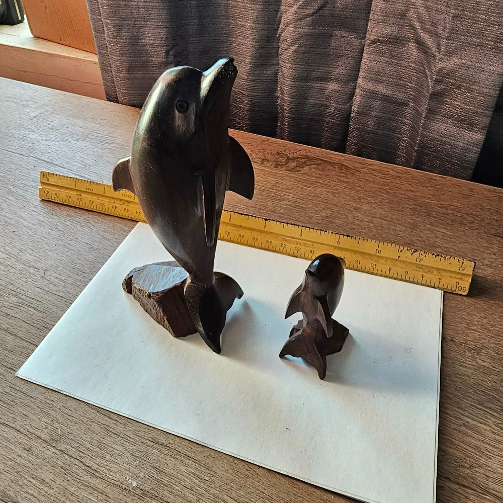 Hand carved wooden dolphins